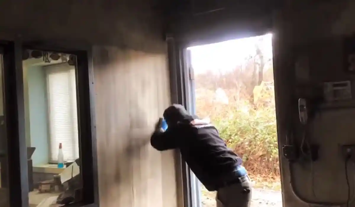 Fire and smoke damage restoration technician assessing residue for a fire damage restoration job in Islip, NY