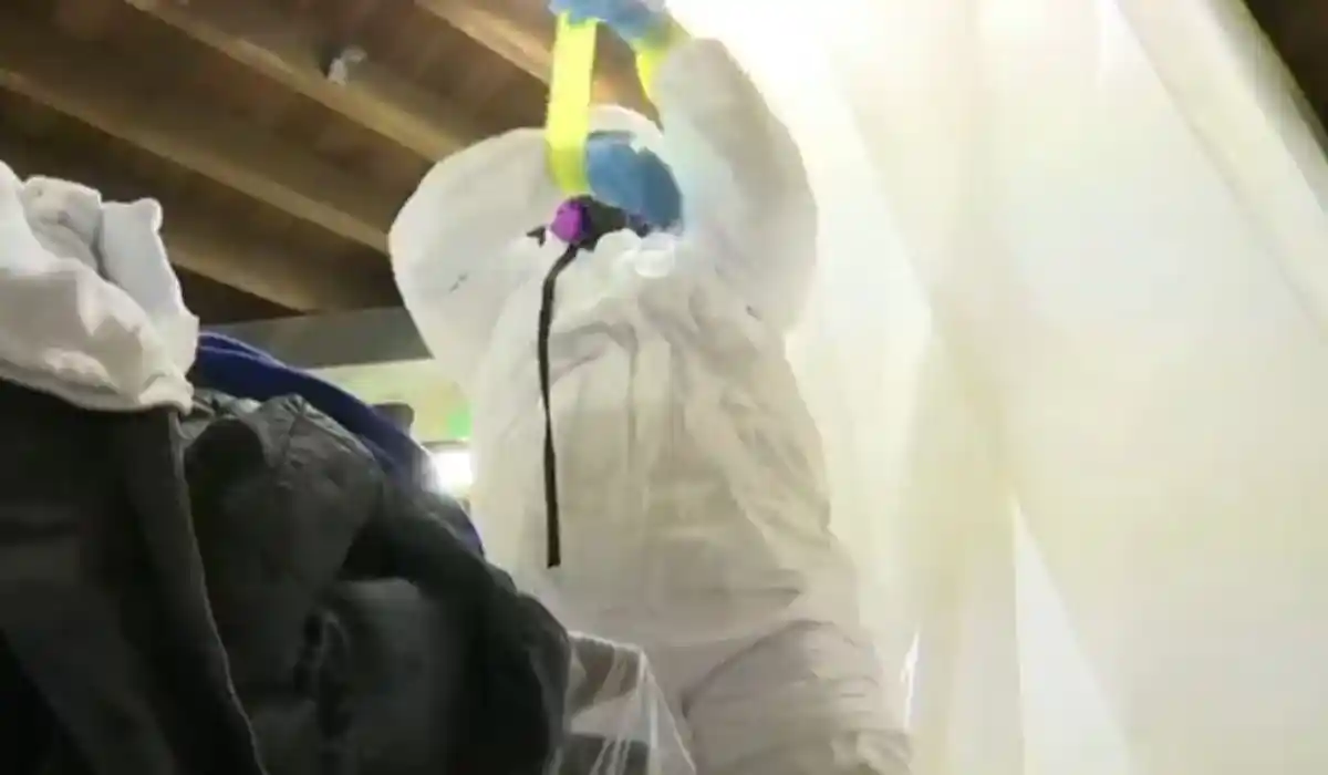 Sewage cleanup crew in protective equipment responding to a contaminated water event in Islip, NY