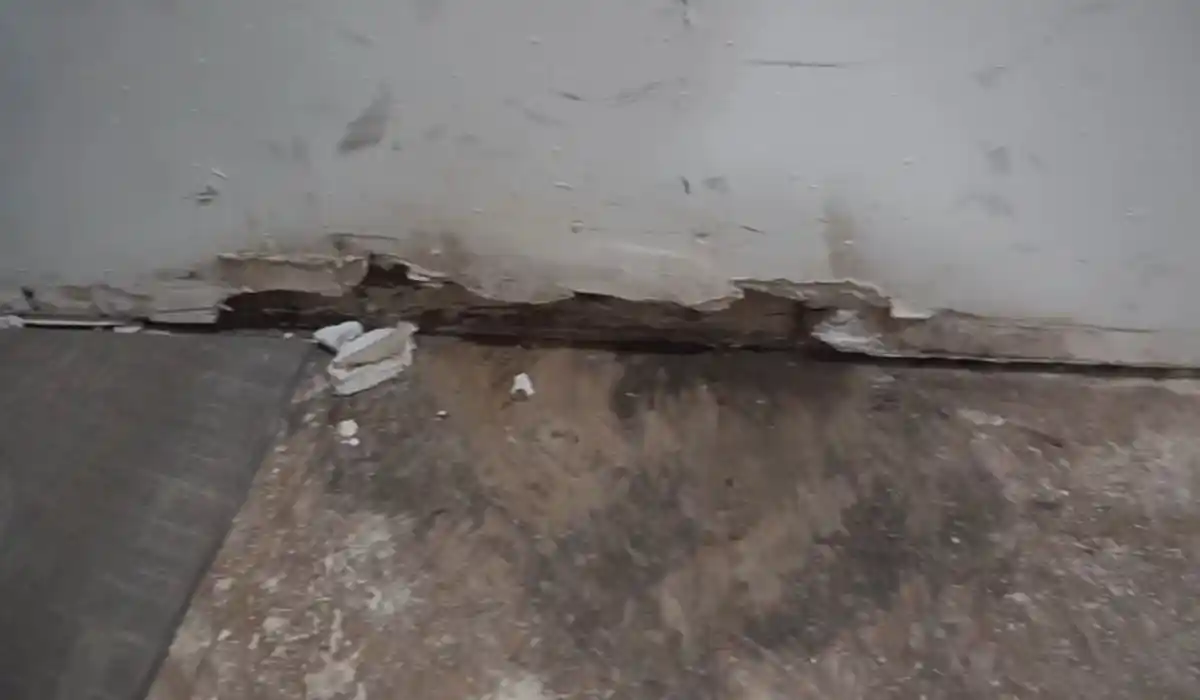 Water damage repair technician restoring a ceiling and structure after extraction and drying in Islip, NY